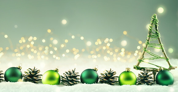 green christmas decorations in front of a sparkling background